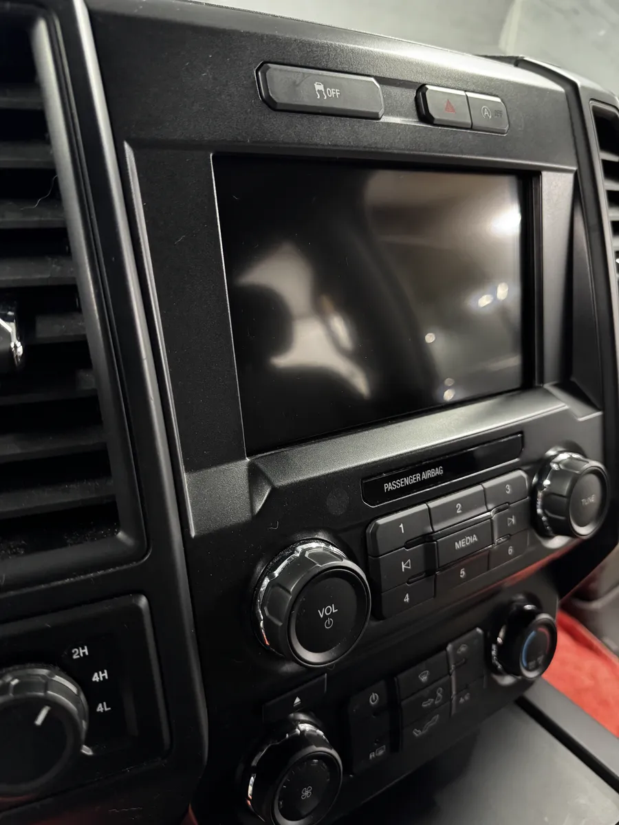 Factory 8-inch Ford F-150 radio screen before the touchscreen upgrade at Xclusive Autosound