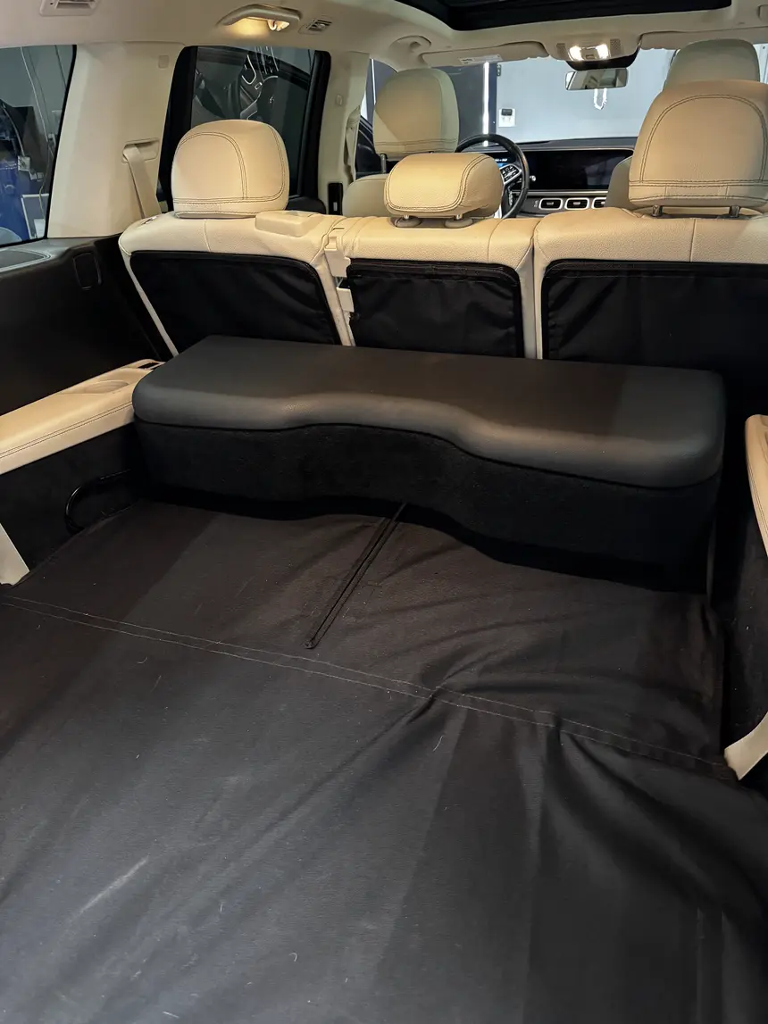 Custom dual 10-inch subwoofer enclosure carpeted to match the cargo floor of a Mercedes SUV, by Xclusive Autosound, Belleville IL
