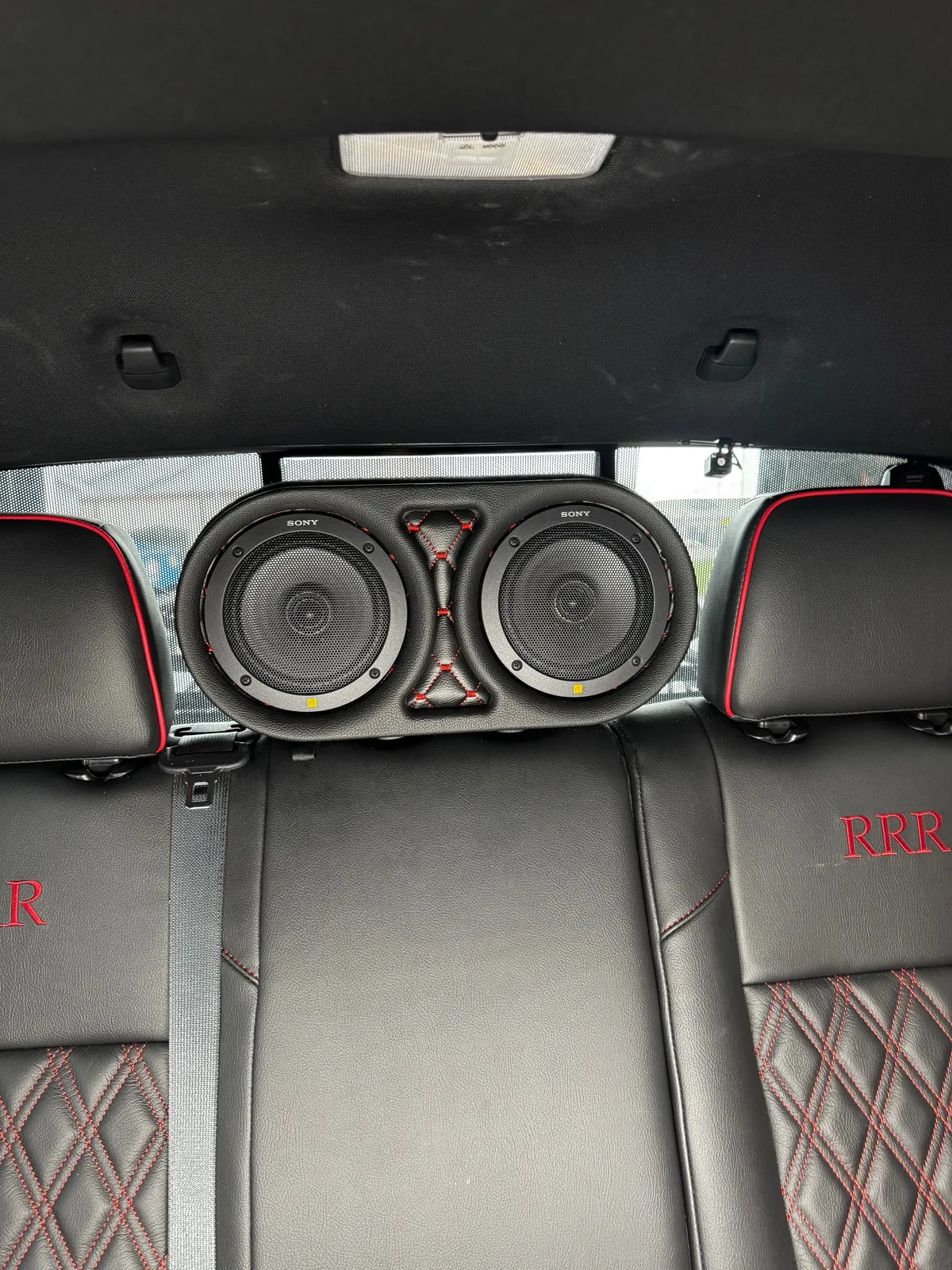 Custom dual rear-deck speakers in upholstered pods, 2023 Toyota Tacoma