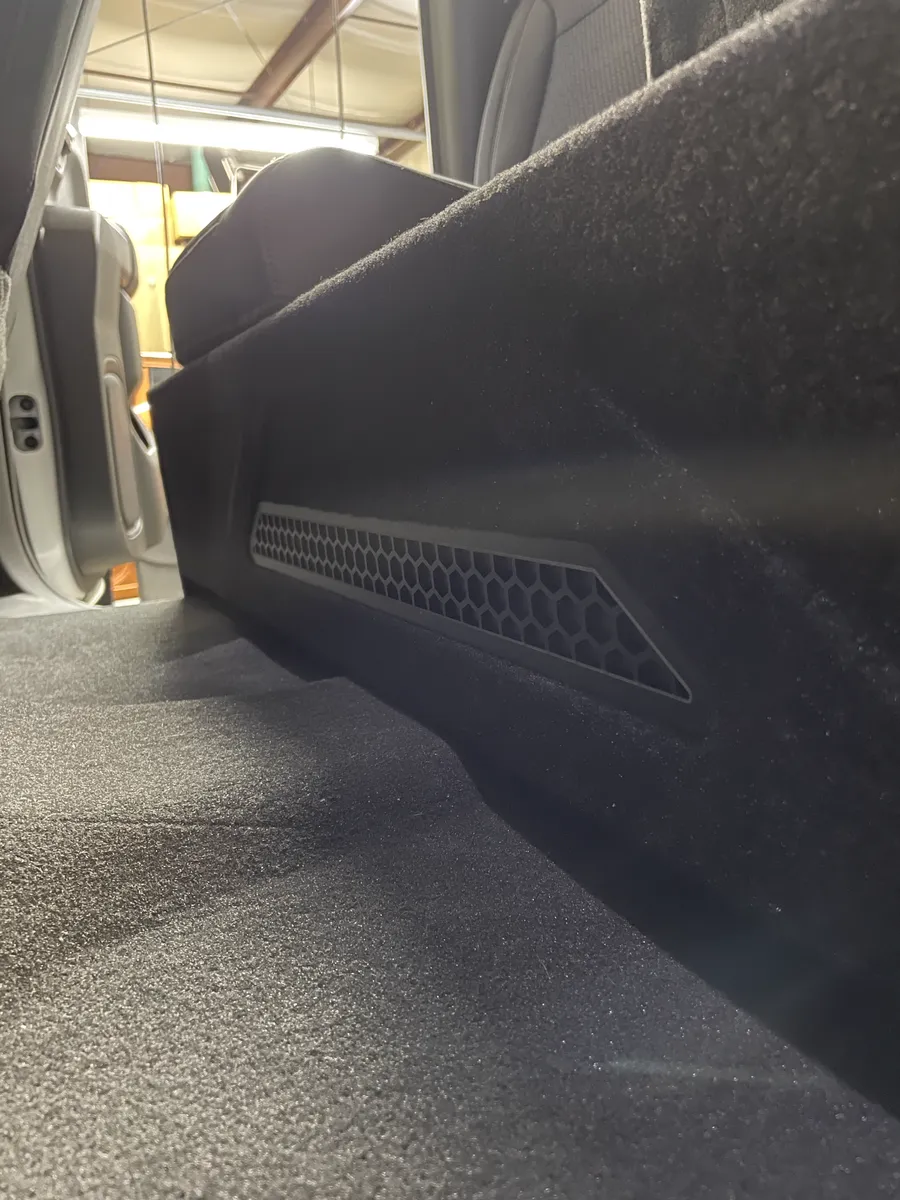 Custom under-seat truck subwoofer box wrapped in matching carpet with a slim hex port, by Xclusive Autosound